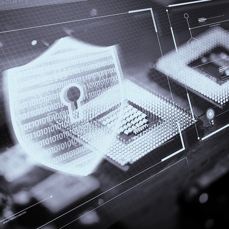 A black and white image of computer chipset with a logo of a shield covered in binary code with a keyhole inside it.
