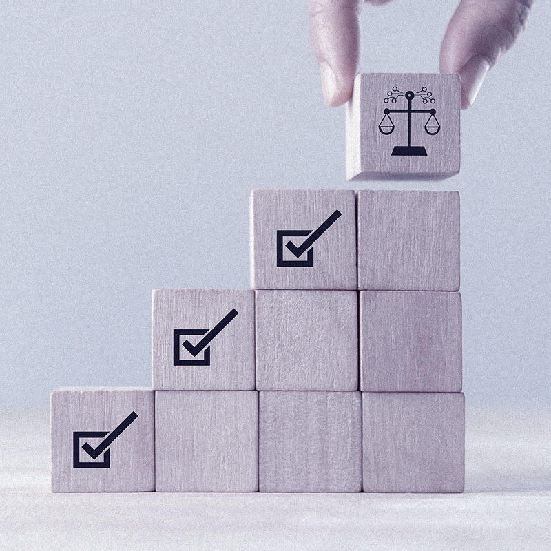 Stack of blocks with a legal scales on top